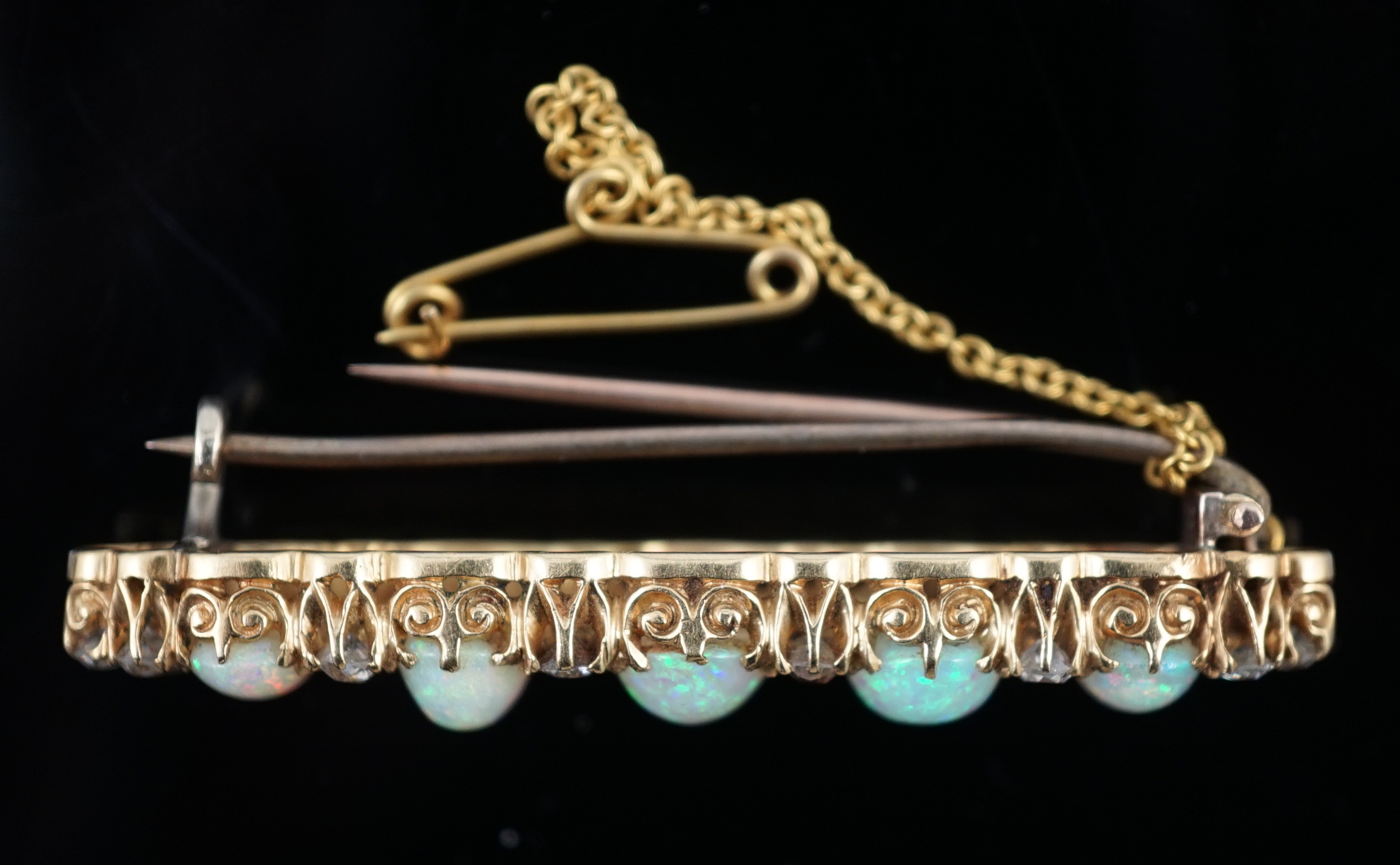 An early 20th century gold, diamond and oval white opal cluster set clip bar brooch